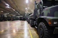 Rows of front loaders and 7-ton trucks sit, gassed up and ready to roll in one of the many corridors in the Frigard supply cave located on the Vaernes Garrison near Trondheim, Norway, Jan. 6, 2012. (U.S. Marine Corps photo/Matt Lyman)
