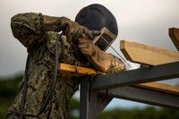 A Seabee welds metal for the Medal of Honor Hospital Corpsman 3rd Class Bush Battle Aid Station for the Correctional Custody Unit 2.0 program March 28 aboard Camp Hansen, Okinawa, Japan. (U.S. Marine Corps/Cpl. Tayler P. Schwamb)