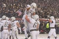 Darnell Woolfolk, #33, celebrates scoring a touchdown during the Army-Navy football game in Philadelphia, Dec. 9, 2017.