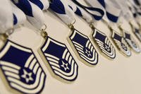 Master sergeant medallions sit on display during the senior noncommissioned officer induction ceremony at the Bay Breeze Event Center Aug. 25, 2017, on Keesler Air Force Base, Mississippi. The ceremony recognized Keesler’s newest senior noncommissioned officers with a candle lighting ceremony and dinner. (Kemberly Groue/Air Force)