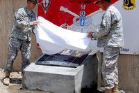 Members of the 173rd Airborne Brigade unveil a plaque and officially name Froward Operating Base Bostick in honor of Maj. Thomas G. Bostick, killed in action in 2007 while commanding Bulldog Troop, 1st Squadron, 91st Cavalry Regiment. (Chris Bradley/Army)