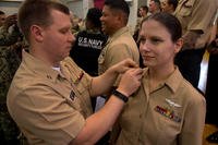 Legalman 1st Class Ashley Dier is pinned by Lt. Jason Bentley, staff judge advocate at Commander, Fleet Activities Sasebo, during a frocking ceremony at Fleet Activities Sasebo, on Nov. 29, 2018. (U.S. Navy photo/David R. Krigbaum)