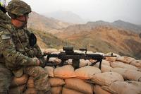 An infantryman with the 10th Mountain Division surveys the surrounding area before heading down the mountain after spending the night on an observation post Sept. 27, 2013 on Forward Operating Base Torkham, in Nangahar Province, Afghanistan. (U.S. Army/Staff Sgt. Jerry Saslav)