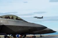 An F-15E Strike Eagle takes off behind 1st Fighter Wing F-22 Raptors stationed out of Joint Base Langley Eustis, Virginia, during Gunfighter Flag, April 5, 2019 at Mountain Home Air Force Base, Idaho. The exercise Gunfighter Flag is held once a quarter to hone skills of 366th Fighter Wing Airmen. (JaNae Capuno/U.S. Air Force)