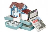 model house with calculator and stack of money