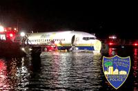 In this photo released by the Jacksonville Sheriff's Office, authorities work at the scene of a plane in the water in Jacksonville, Florida, Friday, May 3, 2019. Officials say a charter plane traveling from Cuba to north Florida ended up in a river at the end of a runway. A Naval Air Station Jacksonville news release says a Boeing 737 arriving from Naval Station Guantanamo Bay, Cuba, crashed into the St. Johns River Friday night. (Jacksonville Sheriff's Office via AP)