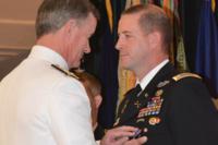 Adm. William H. McRaven pins on the Distinguished Service Cross on Chief Warrant Officer Jason W. Myers, 3rd Special Forces Group (Airborne), June 11, 2012. This was his first Distinguished Service Cross. (U.S. Army photo/Marcus Butler)