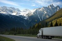 Trucking through mountains. (Stock image)