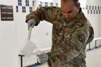 Senior Airman Mizraim Diaz-Roman, bioenvironmental water program manager, 379th Expeditionary Medical Operations Squadron, acquires a water sample for testing, August 22, 2018. (U.S. Air Force/Staff. Sgt. Enjoli Saunders)