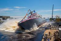 The U.S. Navy’s future littoral combat ship USS Billings (LCS 15) launches sideways into the Menominee River in Marinette, Wisc., following its christening by ship sponsor Sharla Tester. (U.S. Navy photo courtesy of Lockheed Martin/Released)