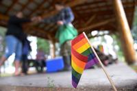 A rainbow flag is placed in the ground for Lesbian, Gay, Bisexual and Transgender Pride Month during the Picnic in the Park at Nussbaumer Park, June 27, 2015, in Fairbanks, Alaska. More than 200 flags were handed out to members of the 354th Fighter Wing and members of the local community. (U.S. Air Force photo by Senior Airman Ashley Nicole Taylor/Released)
