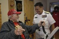 Rear Adm. Bette Bolivar, the Commander of Navy Region Southeast, speaks with a veteran during a visit to Alexander Nininger Veterans Nursing Home as part of Fleet Week Port Everglades, Pembroke Pines, FL, May 4, 2018. (U.S. Marine Corps/Lance Cpl. Leynard Kyle Plazo)