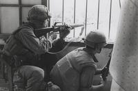 Marines A Company, 1st Battalion, 1st Marines [A/1/1] return fire from a house window during a search and clear mission in the battle of Hue, February 1968. (U.S. Marine Corps Archives &amp; Special Collections/Sergeant Bruce A. Atwell)