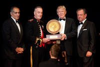 John Mack, left; Commandant of the Marine Corps Gen. Joseph F. Dunford Jr., second left; and Steven Wallace, right, the co-founder of Marine Corps-Law Enforcement Foundation (MC-LEF), award Donald J. Trump during the MC-LEF 20th Annual Semper Fidelis Gala in New York City on April 22, 2015. Trump was a recipient of the Commandant's Leadership award at the event. (U.S. Marine Corps photo by Sgt. Gabriela Garcia)