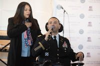 Army Capt. Luis Avila sings the National Anthem as his wife and caregiver Claudia looks on at the start of &quot;A Day of Healing Arts: From Clinic to Community,&quot; an event honoring the importance of healing arts, during Warrior Care Month at National Harbor in Oxon Hill, Maryland on November 16, 2017. (DoD Photo/Roger L. Wollenberg)