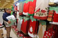Emer Hadley, Keesler Exchange supervisor, sorts and hangs Christmas tree skirts in preparation for holiday shoppers Nov. 19, 2014, at Keesler Air Force Base, Miss. (U.S. Air Force/Kemberly Groue)