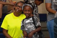 A child smiles at an Air Force event.