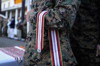 A Marine holds the Afghanistan Campaign Streamer during the battle colors rededication ceremony on Marine Corps Base Camp Pendleton, California.