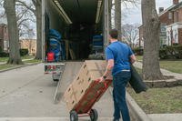 man pushing dolly towards moving truck