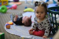 toddler and baby sitting on the floor