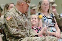 young daughter looking at her father during his change of command