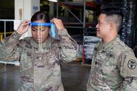 U.S. Army Staff Sgt. Jacklyn Smith adjusts her face shield at Tripler Army Medical Center medical warehouse.