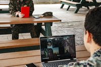 person sitting at a table on zoom