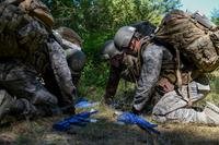 A team of tactical air control party (TACP) officer candidates examine a map