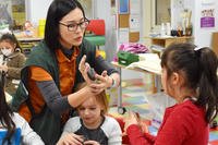 woman instructing children in art