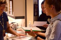 woman presenting paper to another woman