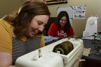 two women working on sewing machines