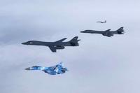 A Ukrainian Su-27 Flanker and MiG-29 Fulcrum escort two B1B Lancers during a training mission for Bomber Task Force Europ.