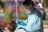 U.S. Air Force Staff Sgt. Michael Jennerman,  performs COVID-19 testing procedures, Grand Junction, Colorado,