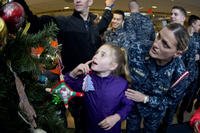 woman and child decorating chrismas tree