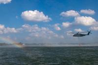 An MH-53E Sea Dragon helicopter performs aerial firefighting training.
