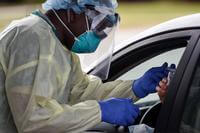 U.S. Air Force Tech. Sgt. Richard Reid, an independent duty medical technician with the 1st Special Operations Operational Medical Readiness Squadron, administers a COVID-19 test at Hurlburt Field, Florida.