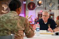 Acting Defense Secretary Christopher C. Miller enjoys Thanksgiving dinner with deployed U.S. troops.