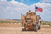 U.S. soldier provides security near a blockade on a road toward Manbij, Syria