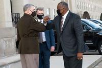 Defense Secretary Lloyd J. Austin III greets Norquist and Milley.