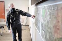 The Rock County Sheriff Commander points on a map to the location of a fatal airplane crash near Janesville, Wisconsin. 