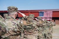 Members of the 138th Fighter Wing render a salute at the Tulsa Air National Guard Base