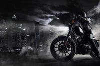 Man riding motorcycle in the city at night