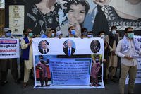 Former Afghan interpreters hold placards during a demonstrations