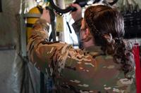 Airman inspects equipment inside a C-130J Super Hercules.