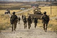 Soldiers make their way to an oil production facility.