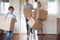 Kids carrying boxes and helping family move