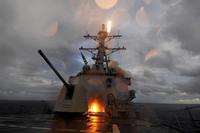 The guided-missile destroyer USS Mustin fires a Standard Missile 2 missile.