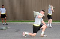 Performing a forward lunge with added weight