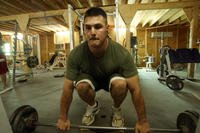 A former personal trainer helps other Marines with their exercise programs.