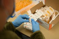 Airman unpacks safety needles.